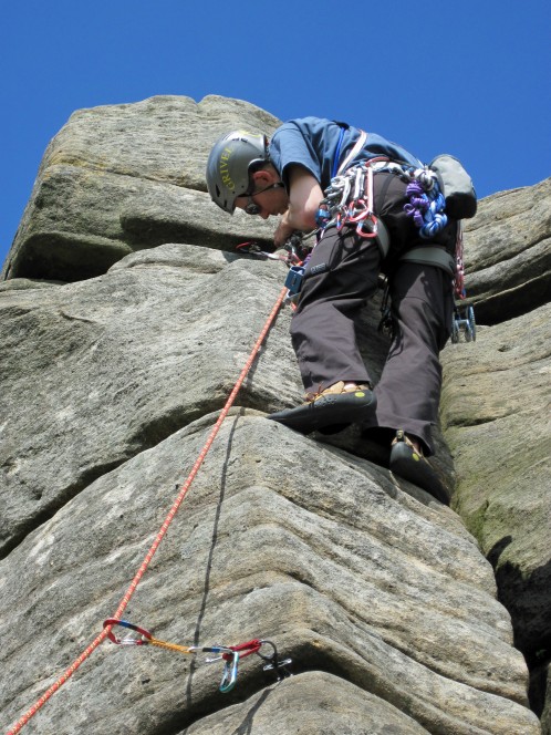 Placing gear on Pillar Arete (VD*) on a hot June day at Stanage Edge.
