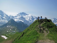 The summit of Mannlichen, with the Monch and Jungfrau behind, in Switzerland.