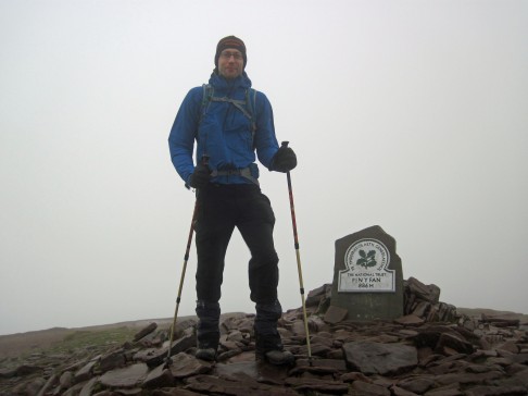 Trying hard to stay standing in strong winds on top of Pen y Fan.