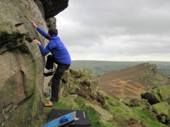Me climbing the boulder problem Goat's Gruff on the base of The Roaches' Upper Tier.