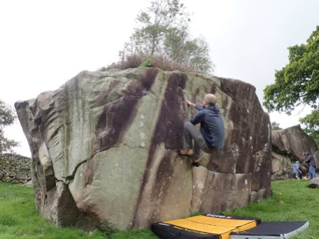 Climbing an unnamed boulder problem on the Bottom Block at the Langdale Boulders.