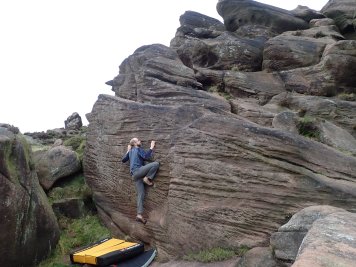 Trying to climb Cellar Slab 2 (V2 5c) in The Cellar area of The Roaches.