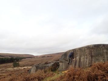 Climbing Kidney Wall (V0+ 5a) on The Kidney boulder at Burbage South Valley.